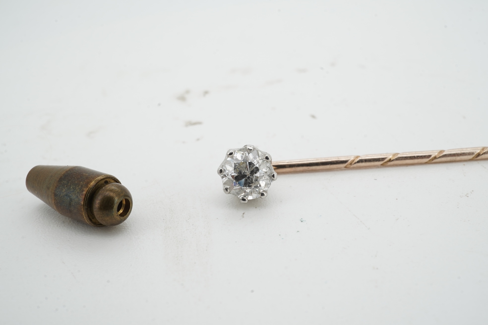 A diamond stick pin, early 20th century, claw-set with a circular-cut diamond weighing approximately 0.50 carats, mounted in gold, length 5.4cm